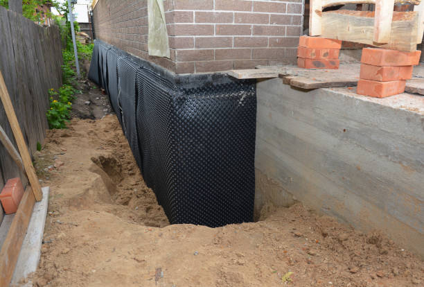 Happy homeowners after waterproofing job in Steele